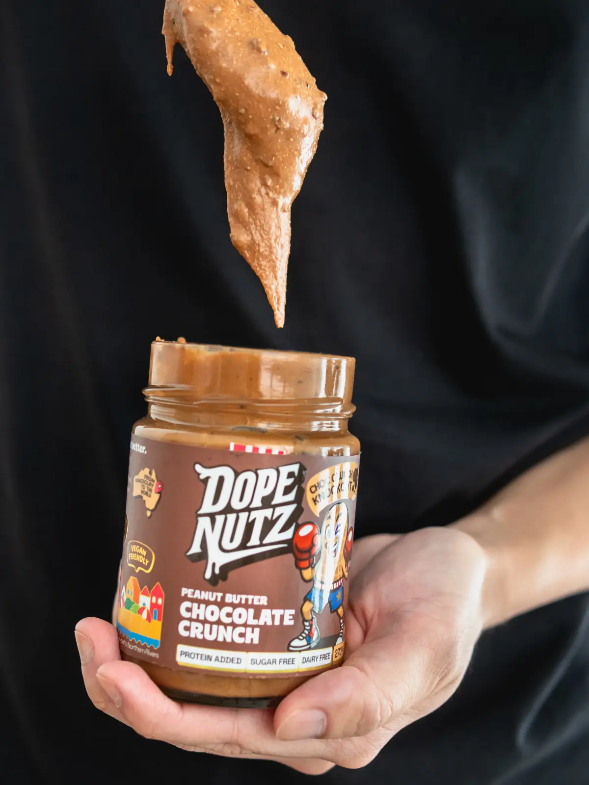 Creative vegan product photography for Dope Nutz peanut butter featuring action drip shot